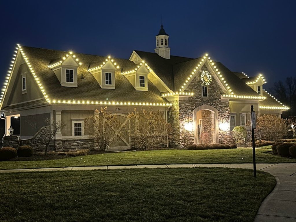 Warm white roofline Christmas lights installed by Lights Around