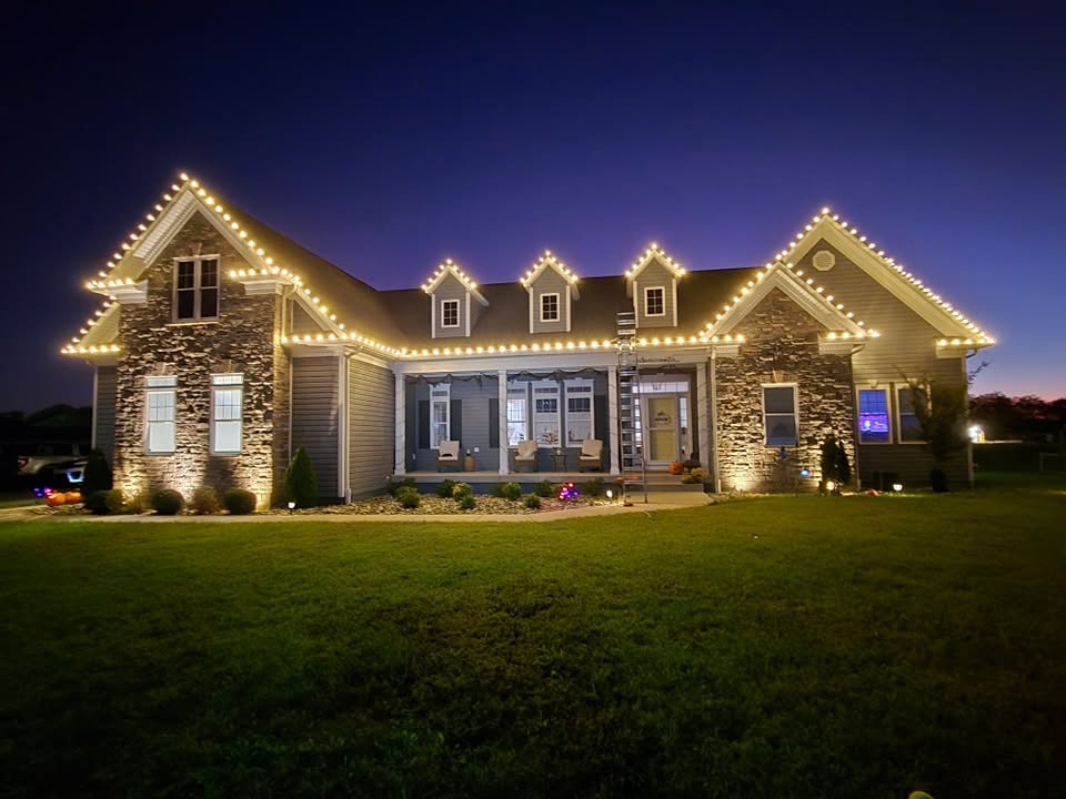 Professional Christmas light installation on a two-story home with warm white LED outdoor lights.