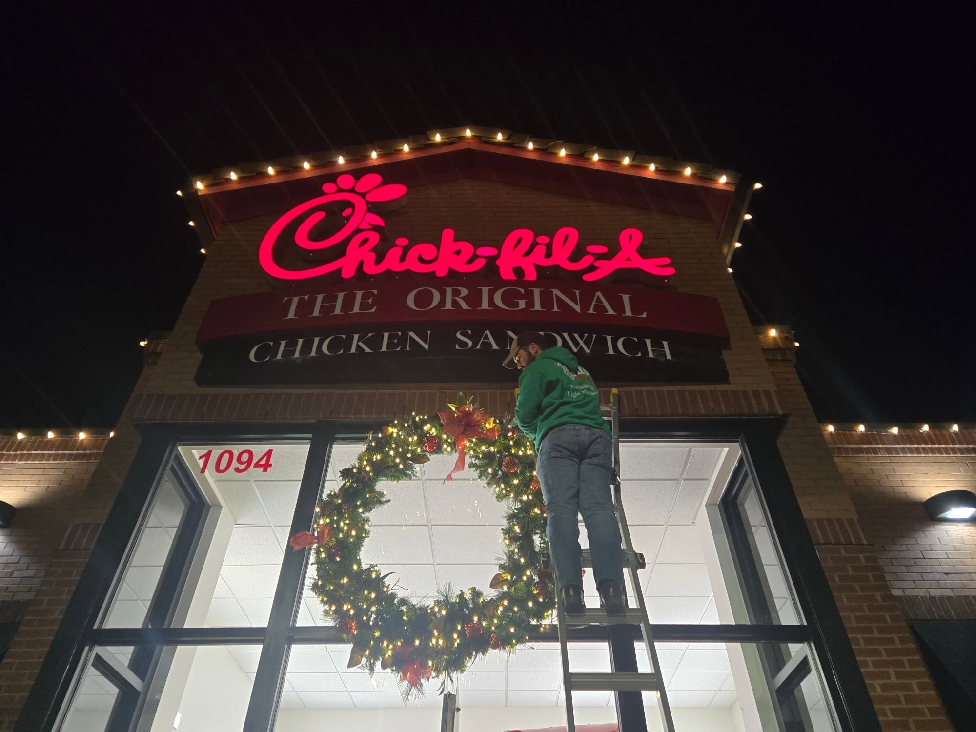 Chick-fil-A storefront in Richmond, VA, decorated with commercial holiday lighting and a wreath