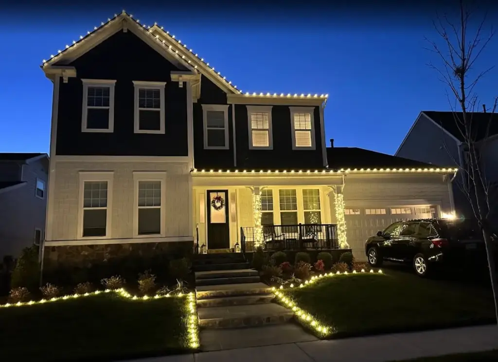 Warm white roofline Christmas lights with pillar wraps and lawn path lights
