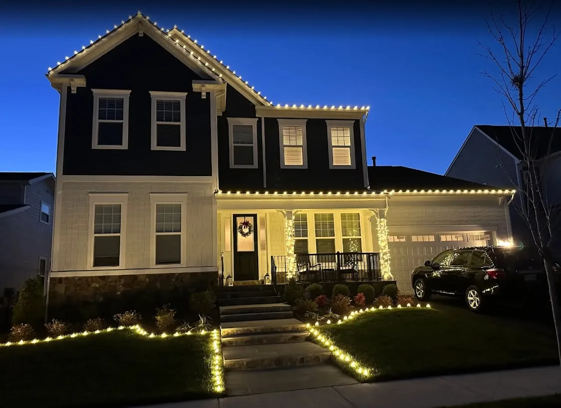 Warm white roofline Christmas lights with pillar wraps and lawn path lights